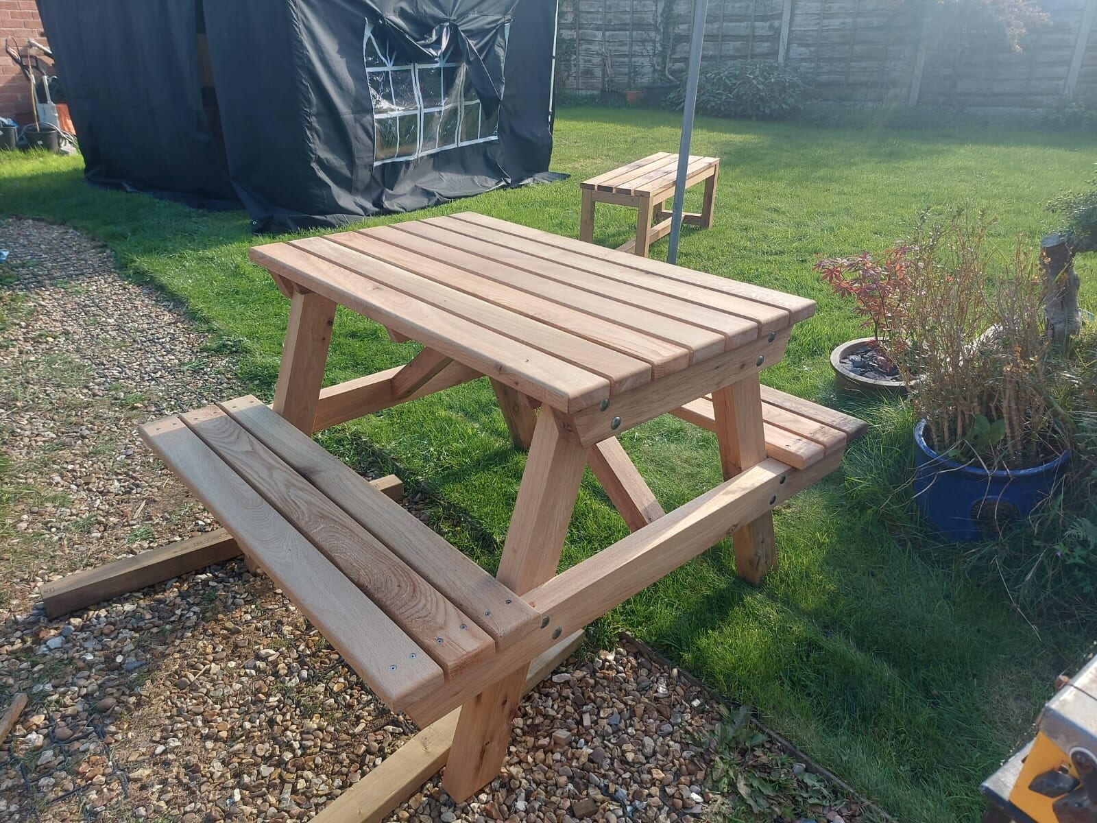 Solid oak picnic bench on a garden lawn