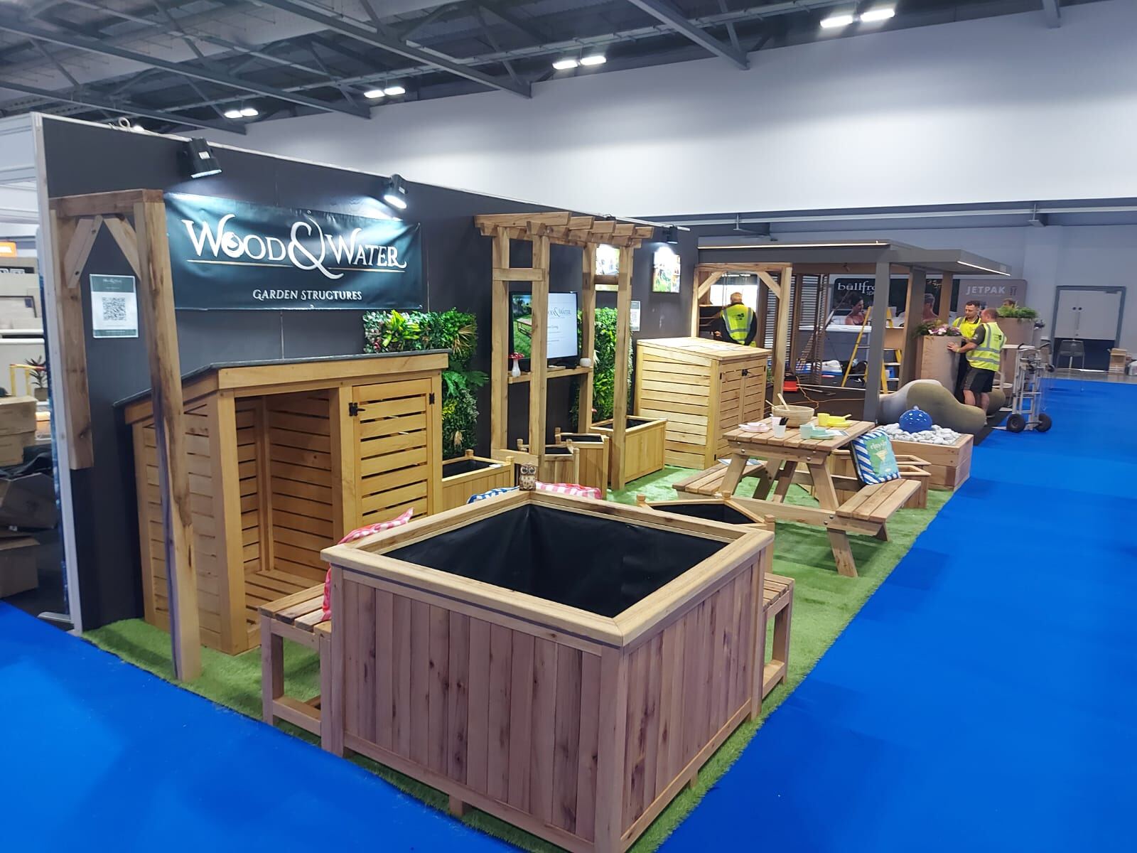 Wood & Water raised sleeper pond displayed with timber garden products at a show