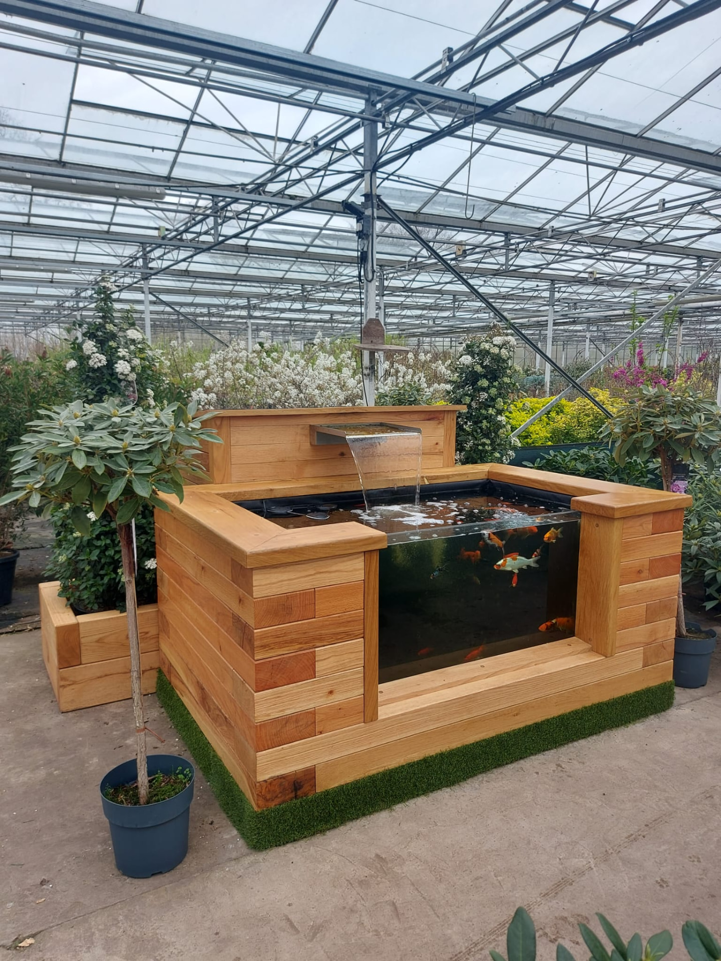 Close detail of solid oak timber joinery on a raised sleeper pond